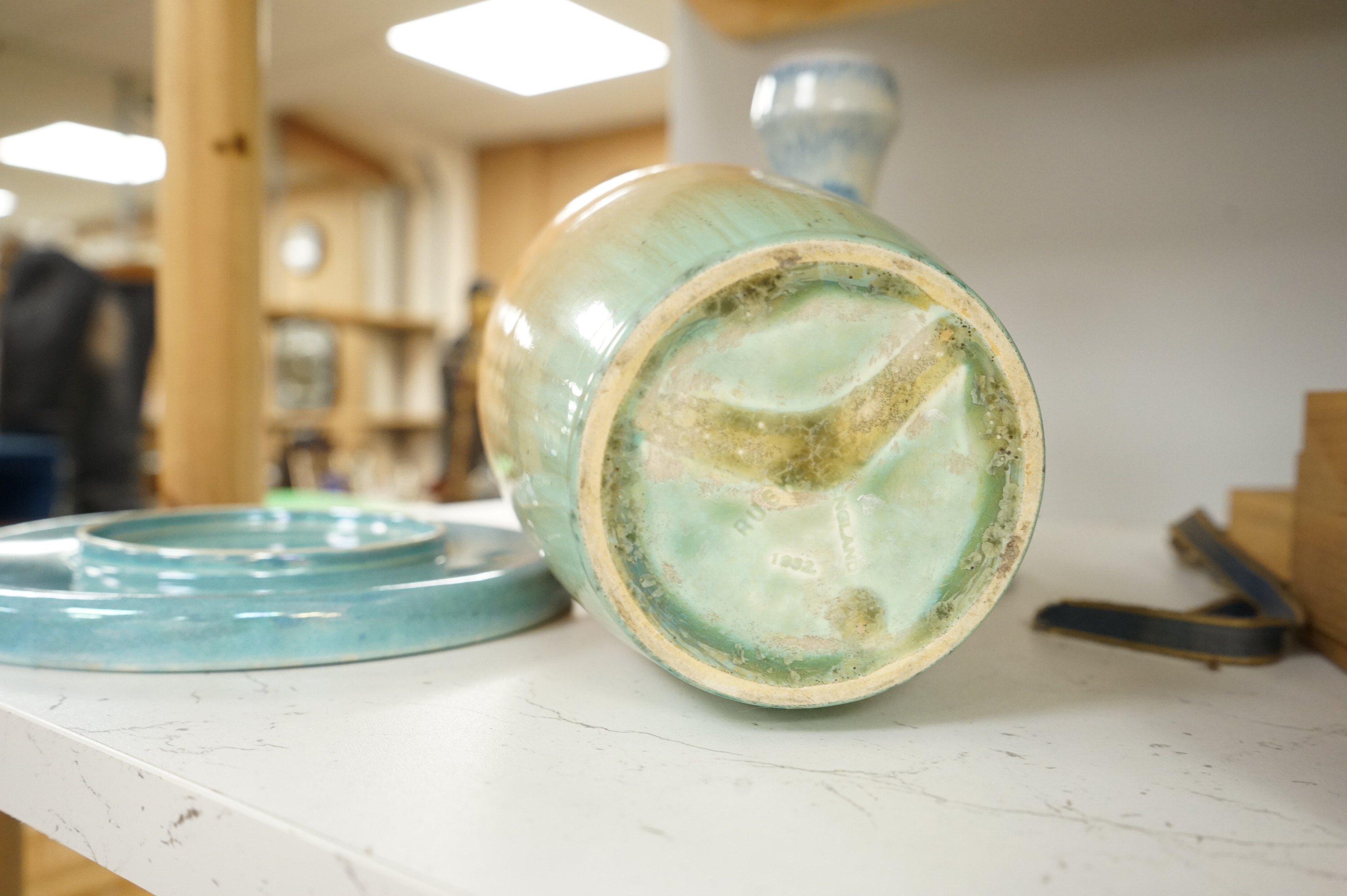 A Ruskin souffle glazed vase, impressed 1932, a Ruskin circular dish and an earthenware candlestick, tallest 21cm (3)